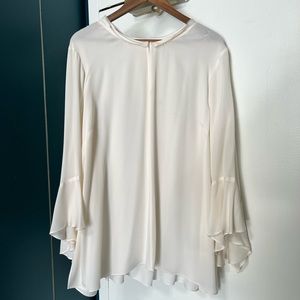 Cream silk blouse with ruffle sleeve detail.
